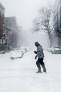 Man walking through snowstorm